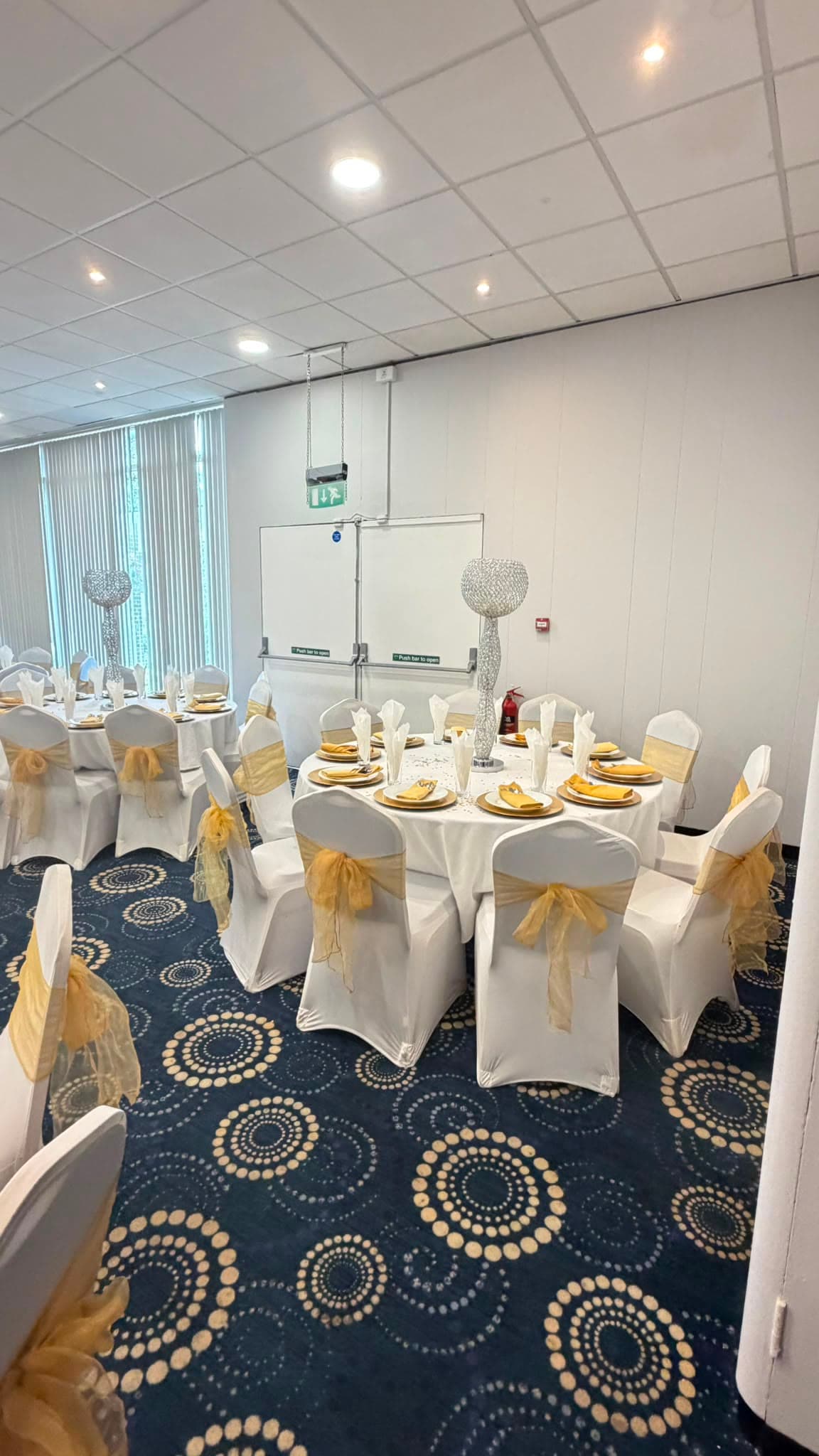 One of the three smaller rooms the suite divides into, laid with round tables for a more intimate function.