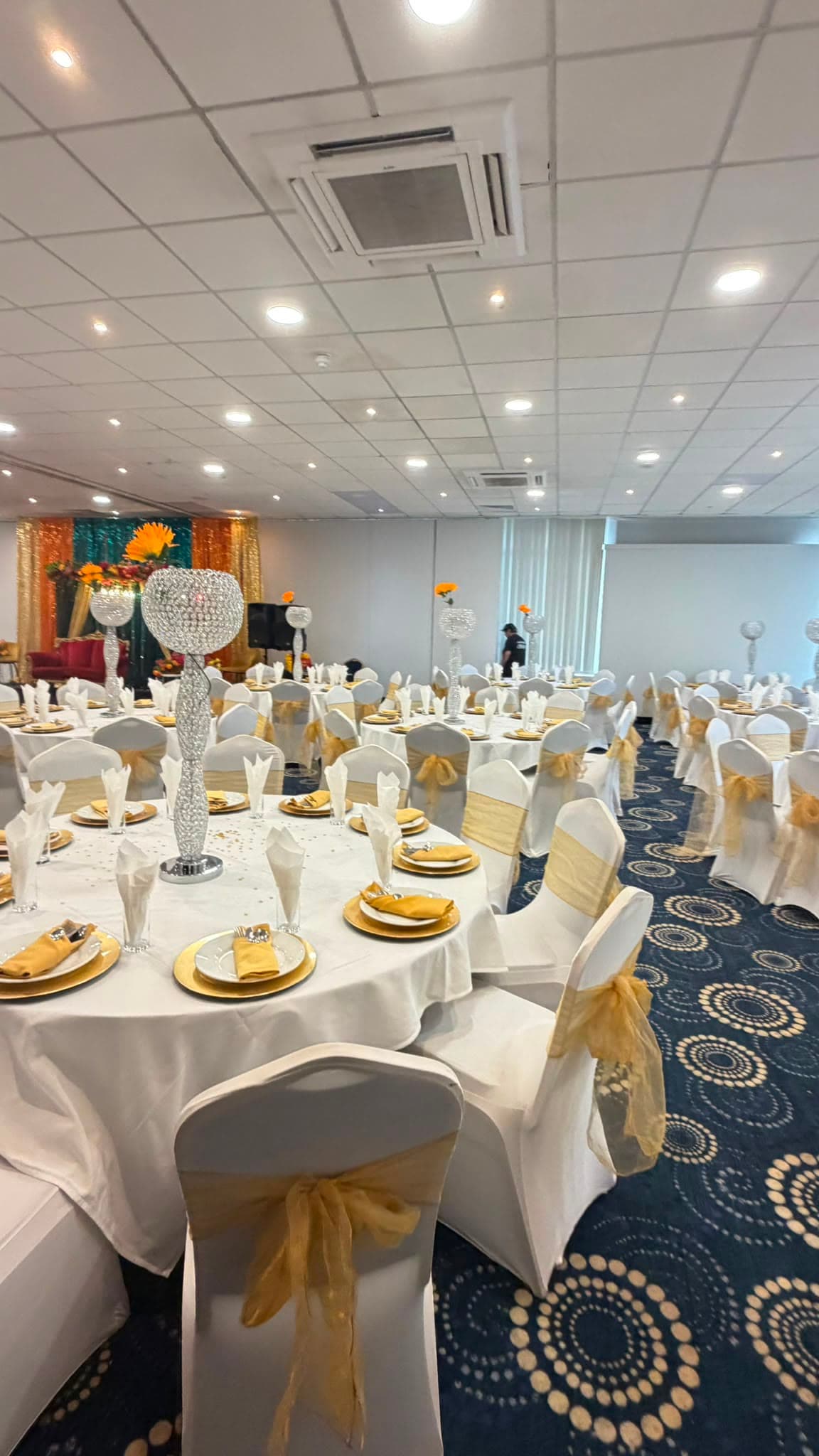 The suite laid for a banquet, seen across a fully set table in the foreground.